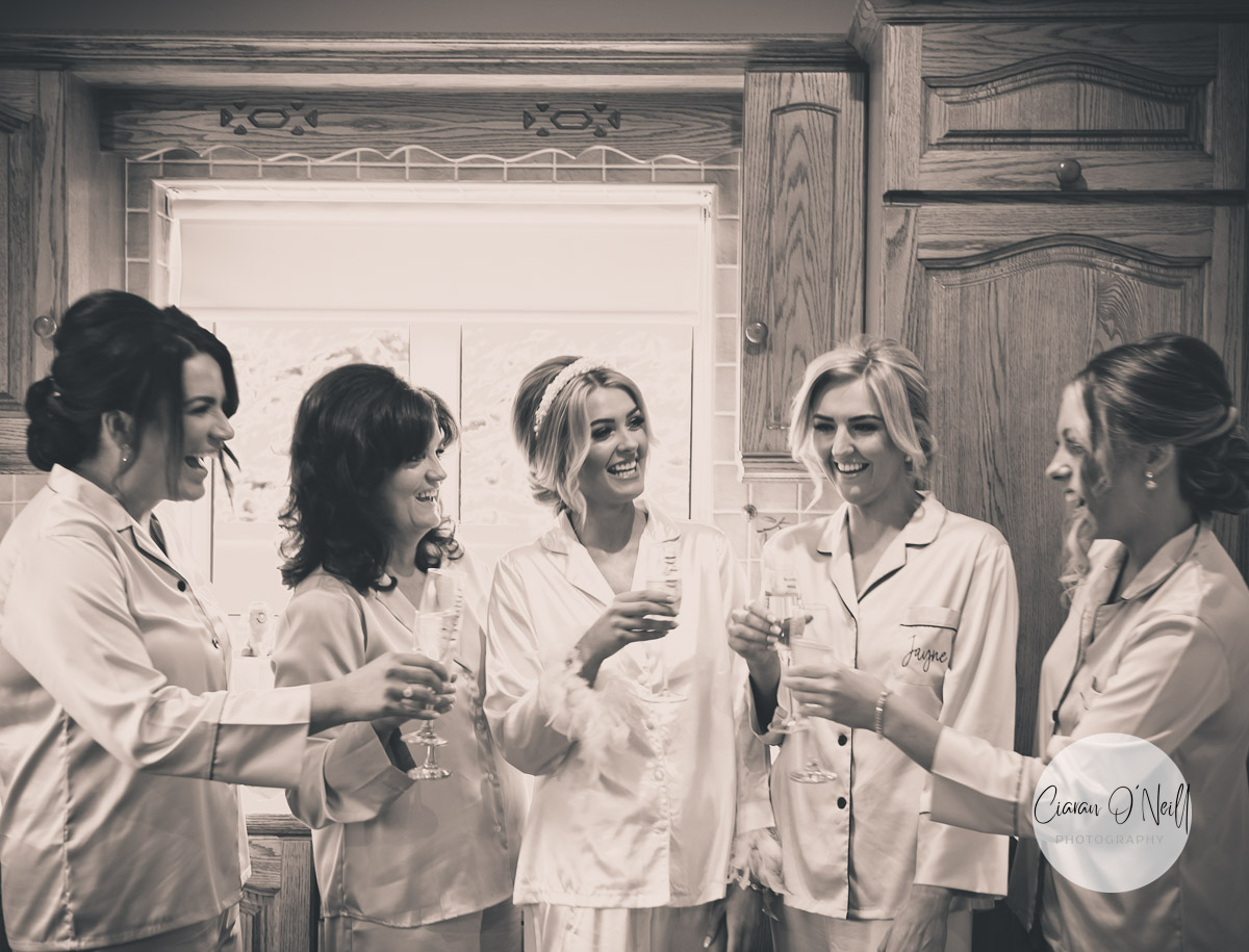 Cara and her bridemaids enjoying a glass of bubbly during the bridal prep