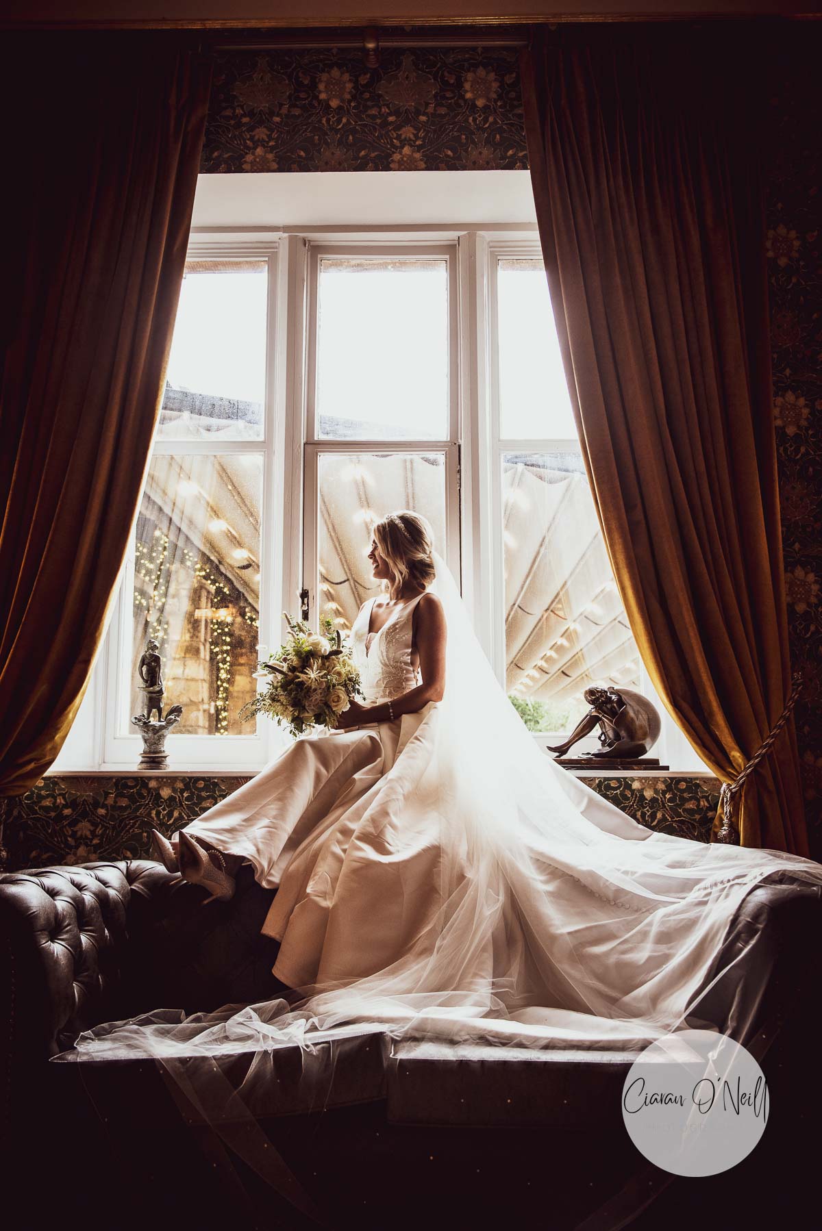 Bride sitting in the window of Cabra Castle