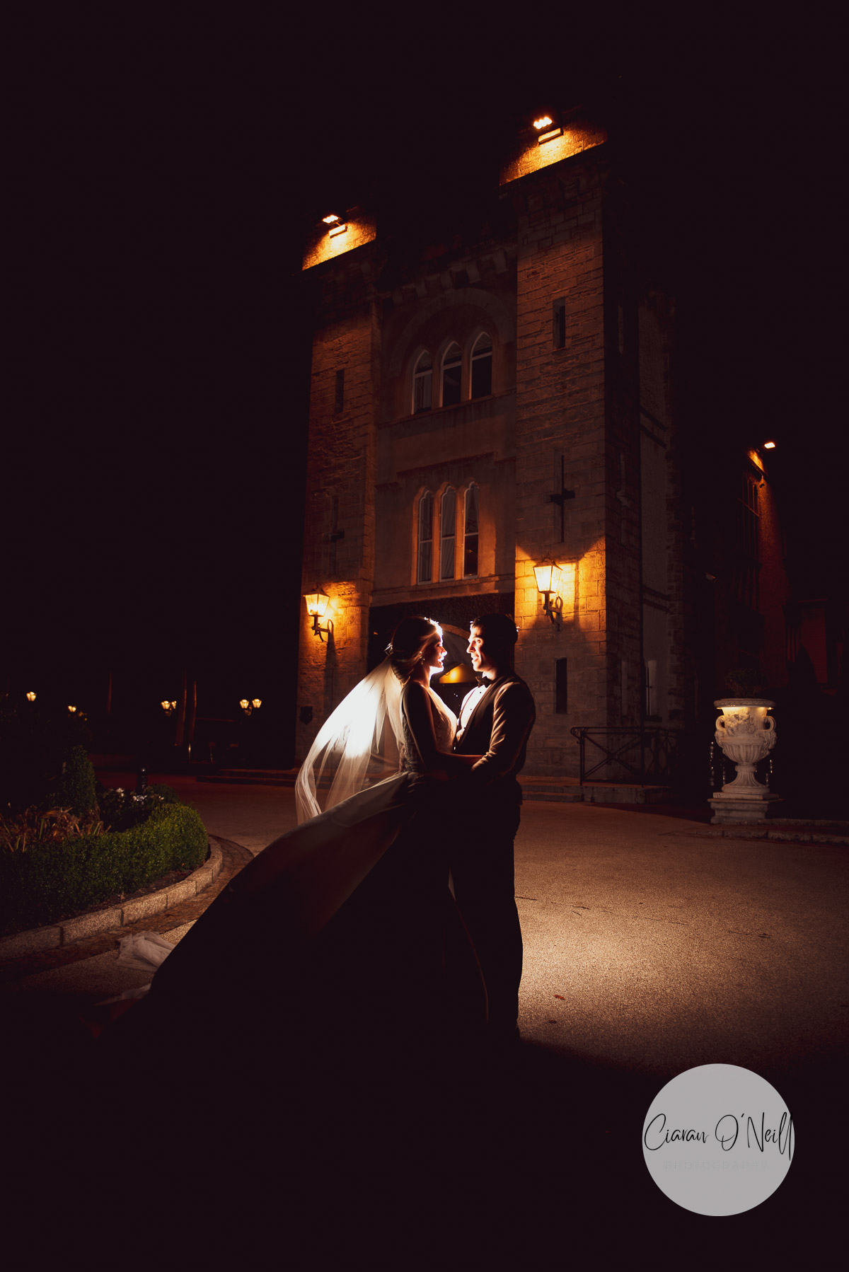 Couple braving the cold for a night time shot outside of Cabra Castle