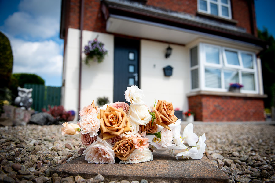 Bridal flowers sitting outside bride's family home