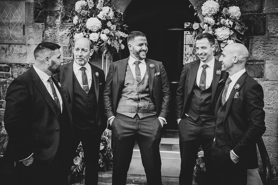Groom and his groomsmen having a laugh just prior to the wedding ceremony