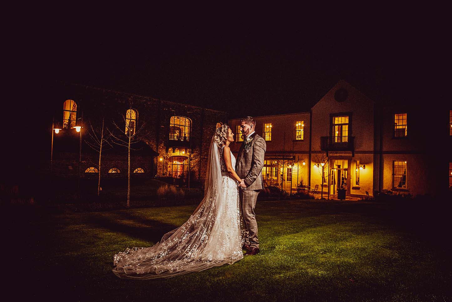 Tips for choosing your wedding photographer - Bride and Groom standing outside the amazing Montalto Estate in the dark - Wedding Photography Northern Ireland at its finest