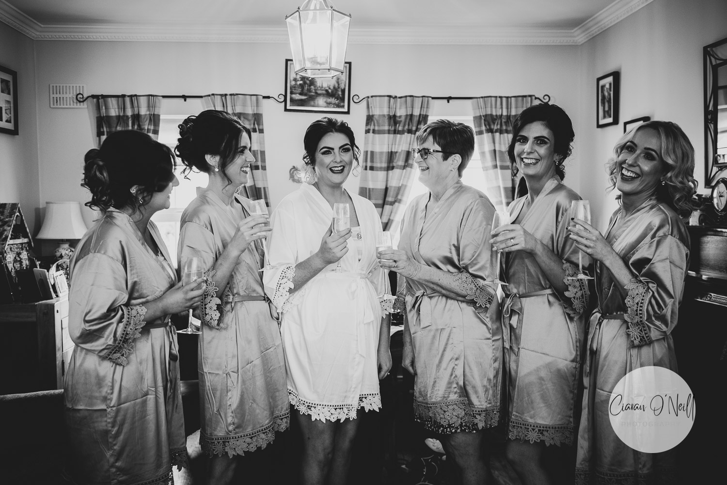 Bride and bridesmaids getting ready and celebrating with champagne