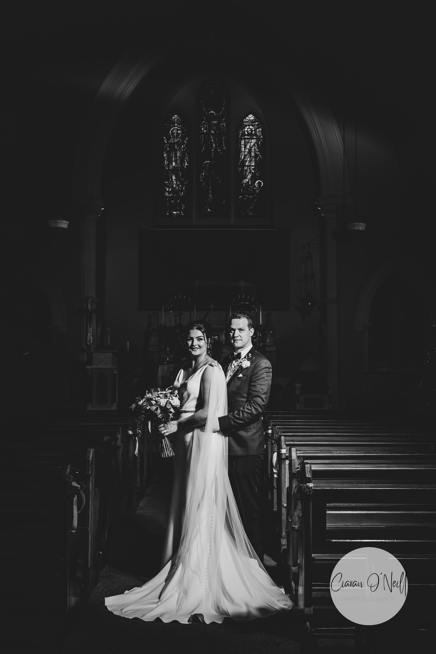 Bride and groom in dark romantic church