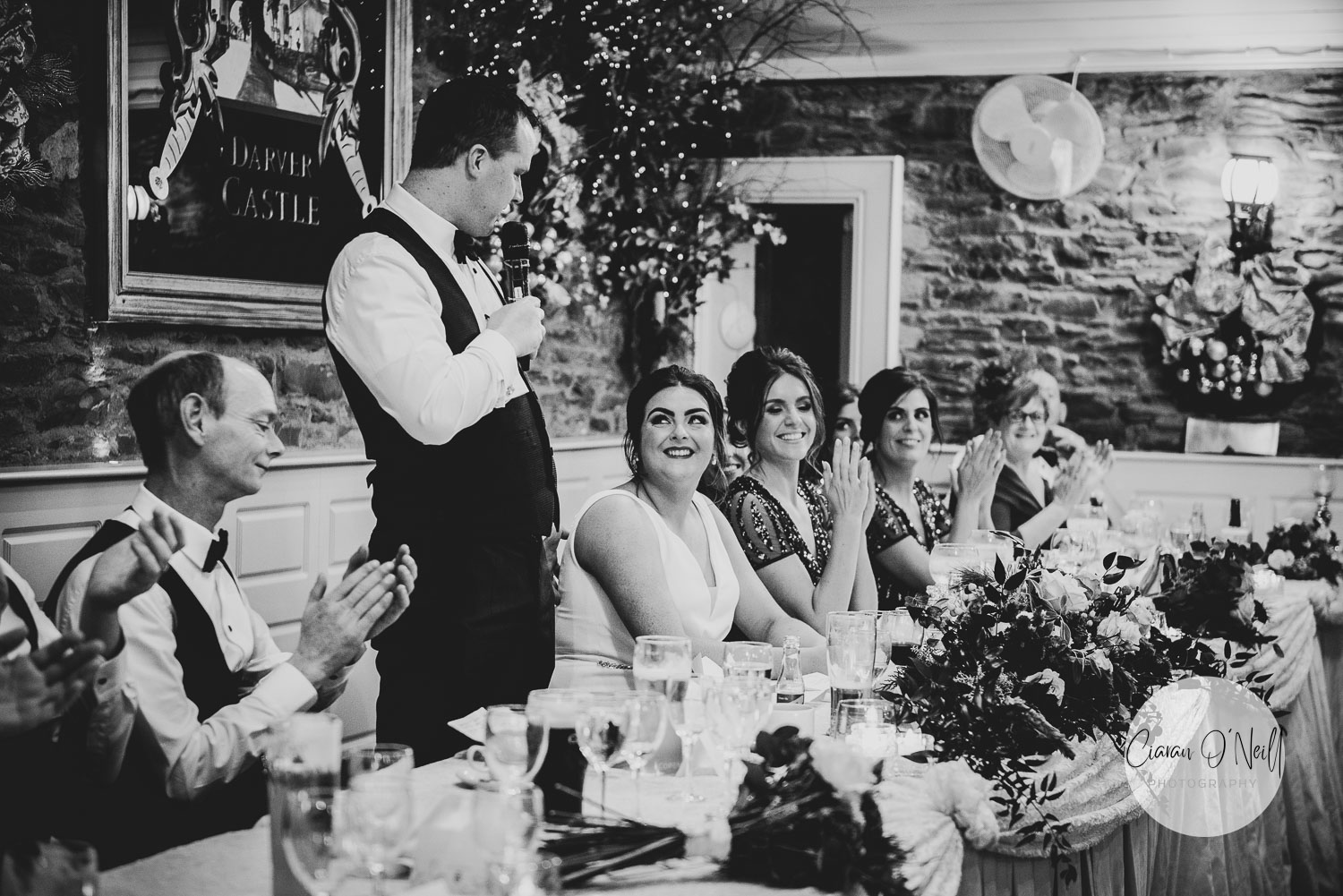 The groom looking at his new wife while making his speech