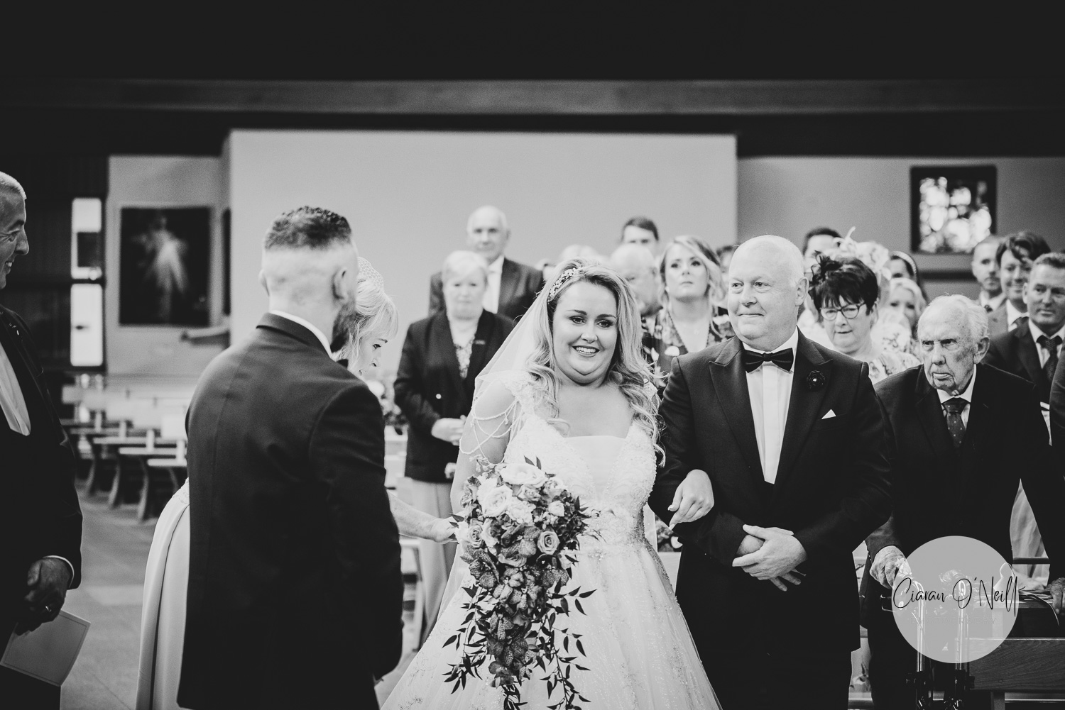 Bride and dad reach an elated Groom at the top of the aisle