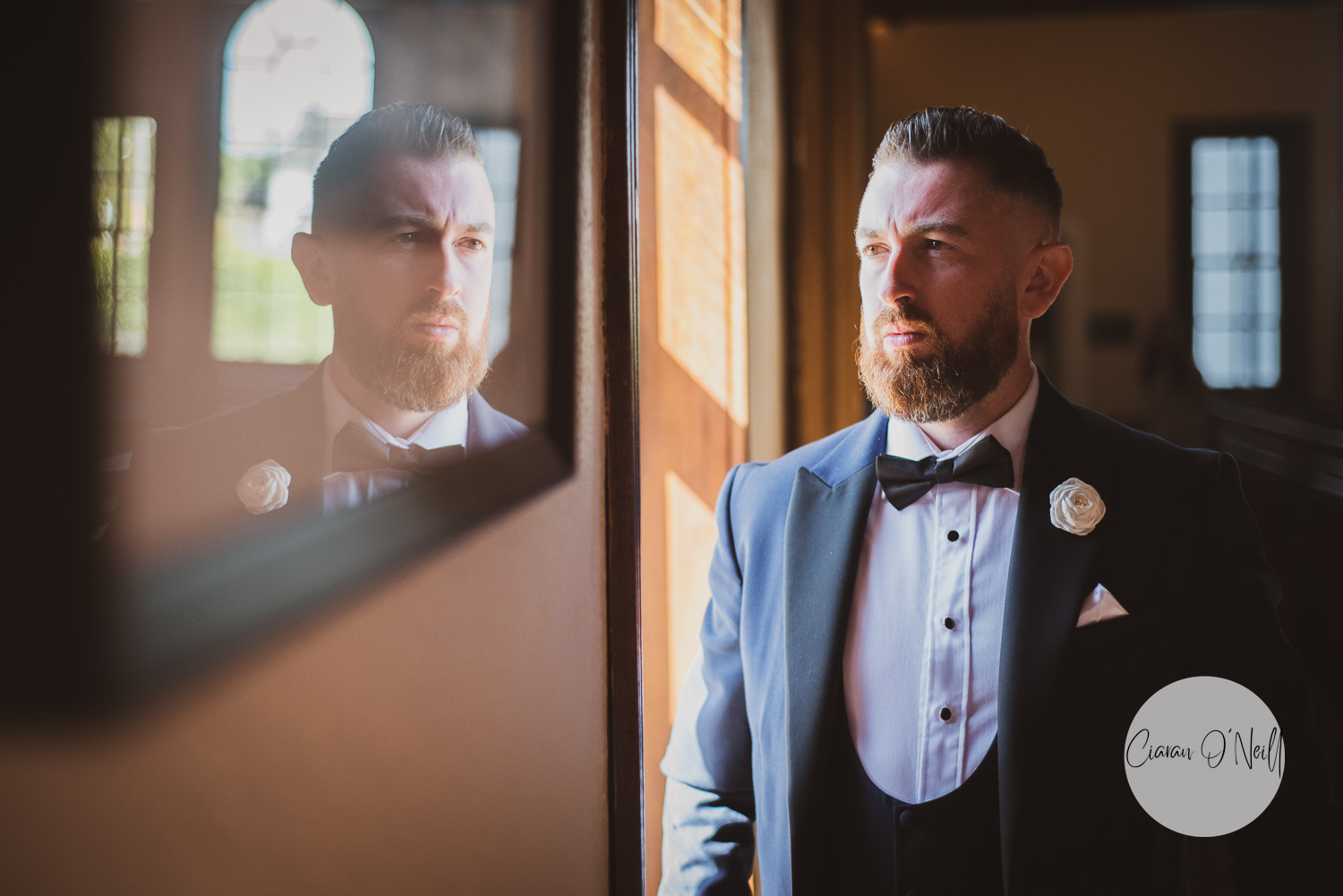 Reflection of the groom in a mirror