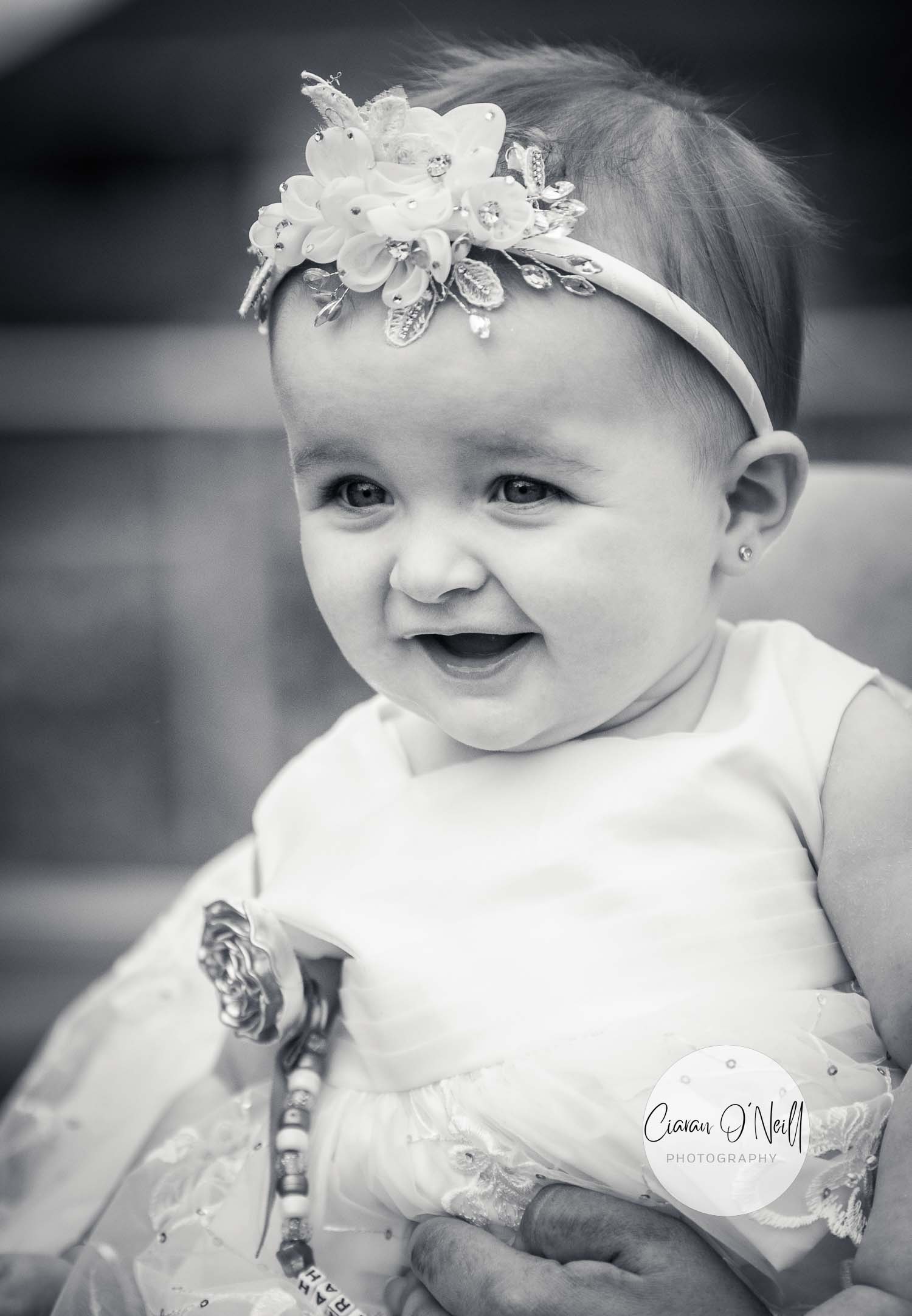 Baby in flowergirl dress at her mum and dad's wedding