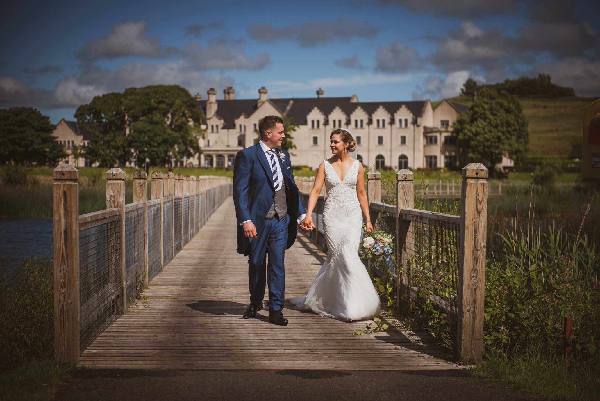Lough Erne Resort - our lovely couple enjoy a stroll across the foot bridge over Lake Hume