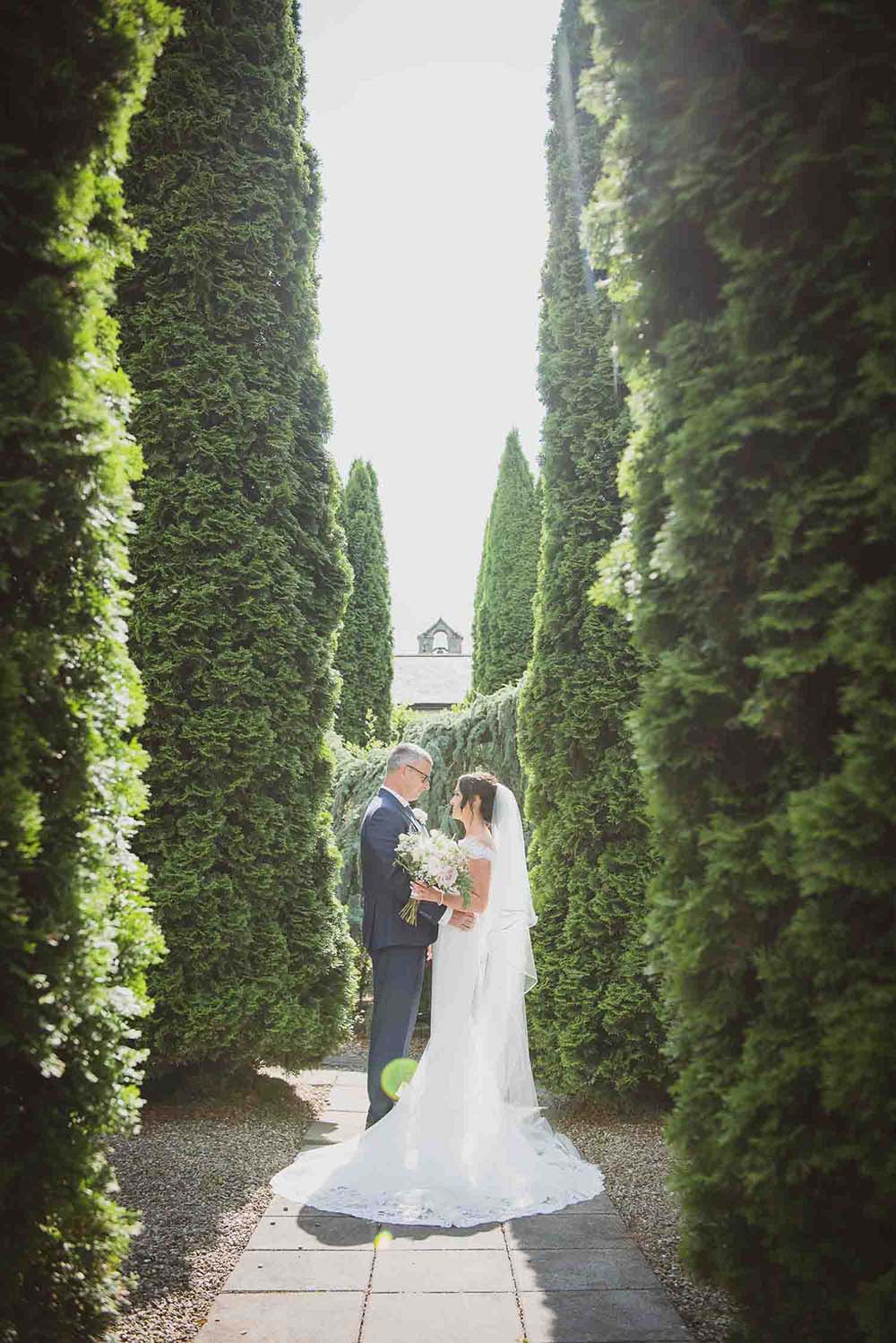 Bride and groom in courtyard garden at Cabra Castle hotel