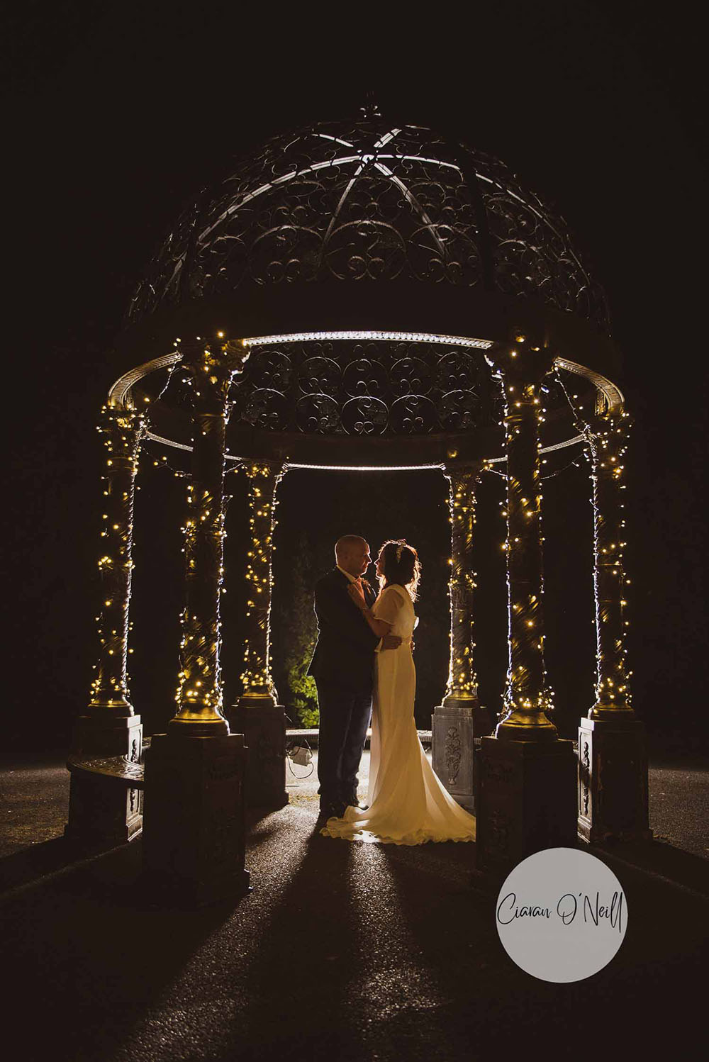 Bride and groom in gazebo at night Cabra Castle Ireland