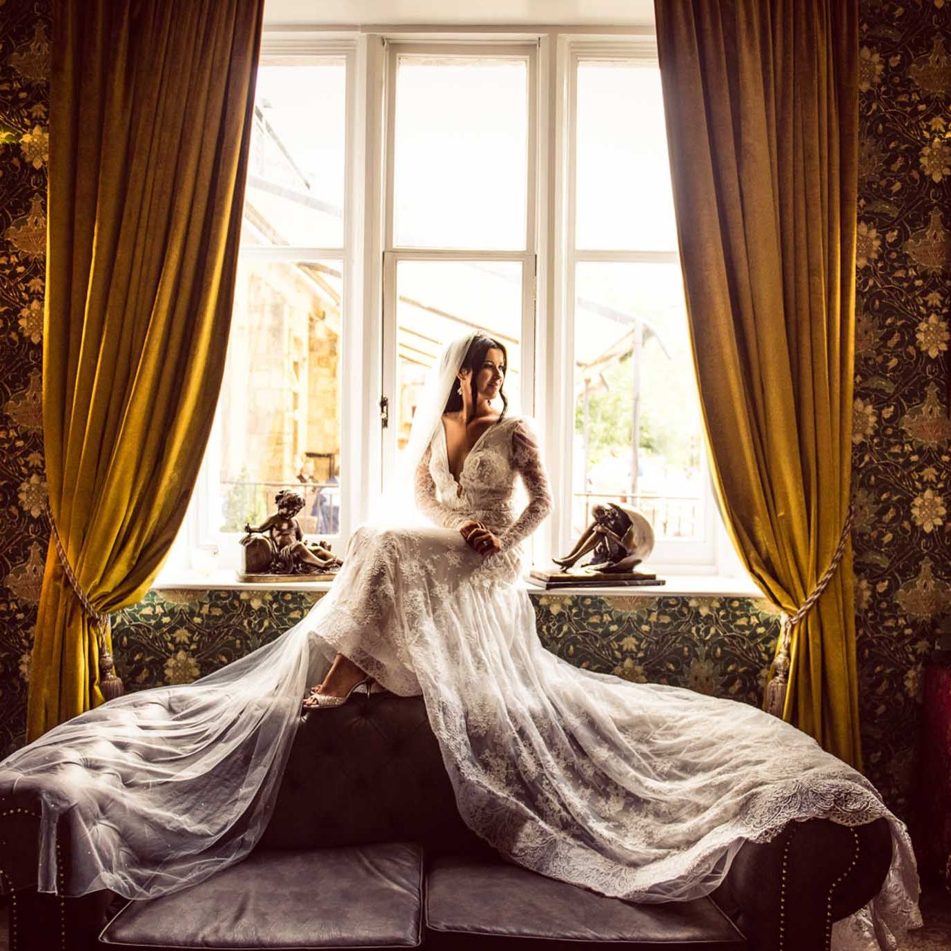 Bride sitting in the window of Cabra Castle