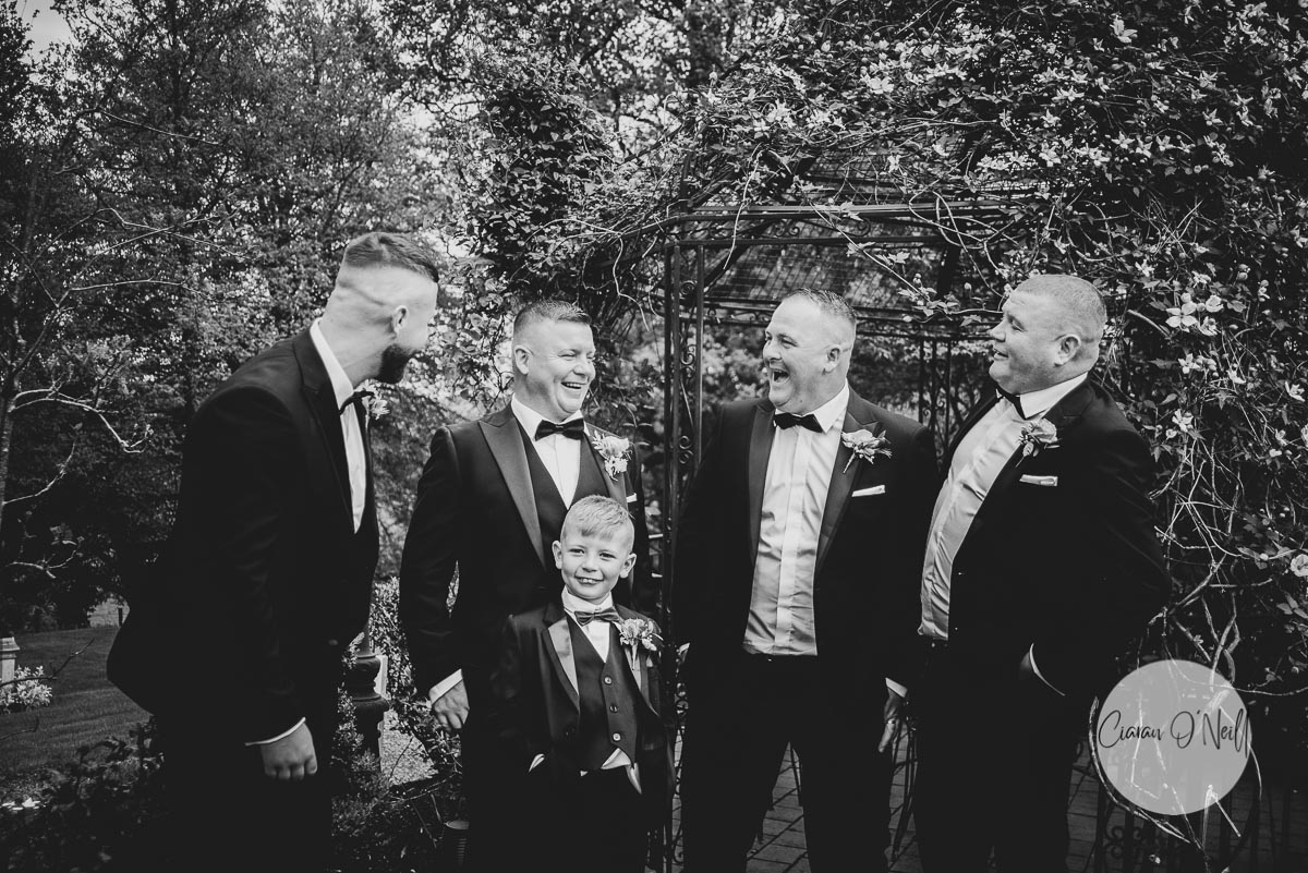 The groomsmen enjoy a laugh in the gardens of Slieve Russell Hotel