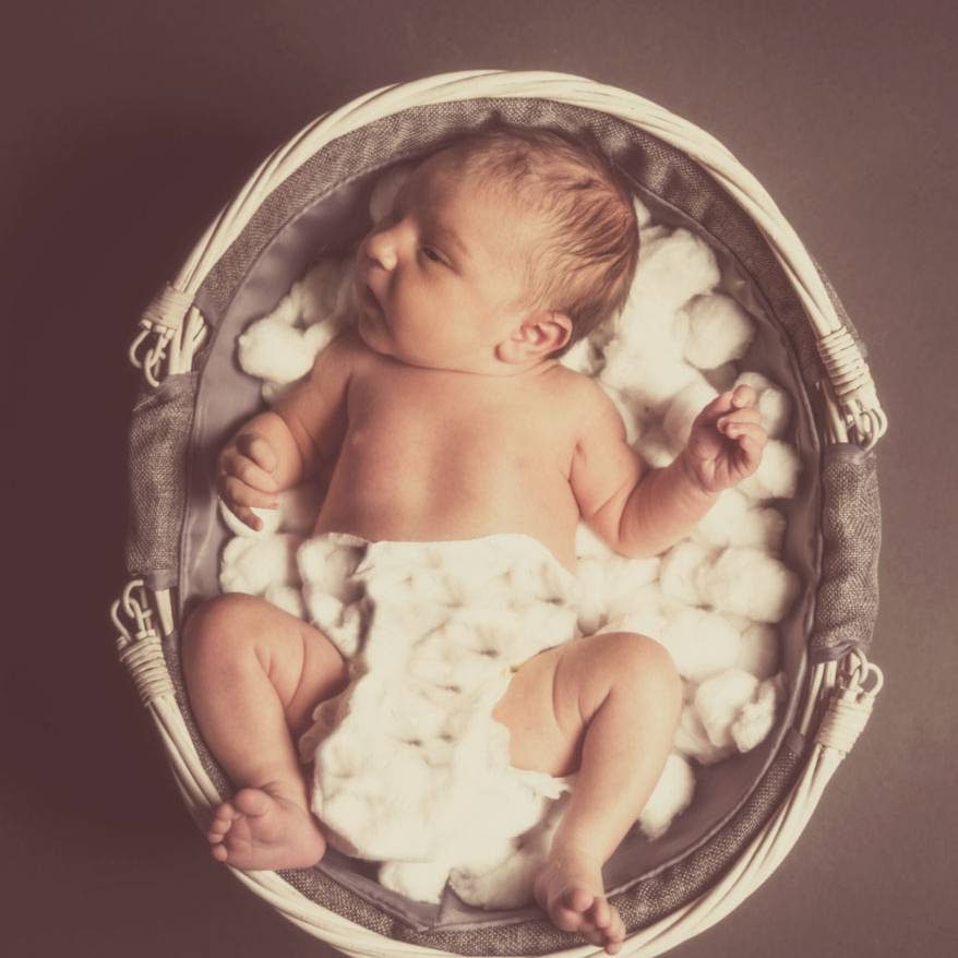 Baby lying on cotton balls