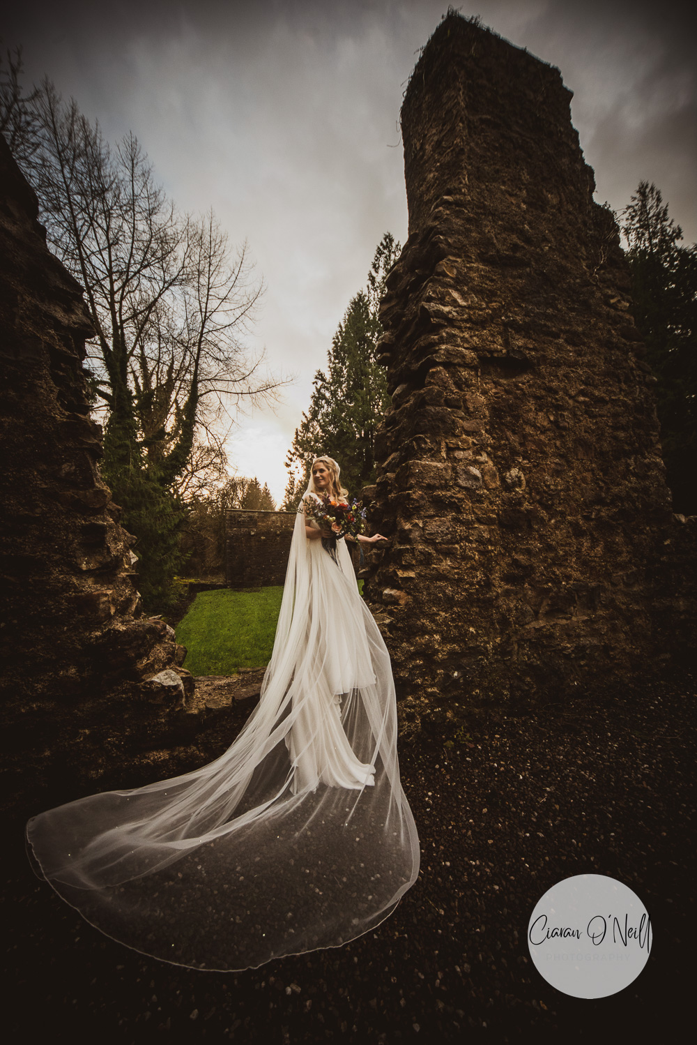 Bride standing on ruins in the Old Castle Archdale