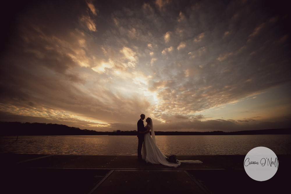 Couple lit by the sunset, standing on a jetty at the Marina, Manor House Hotel