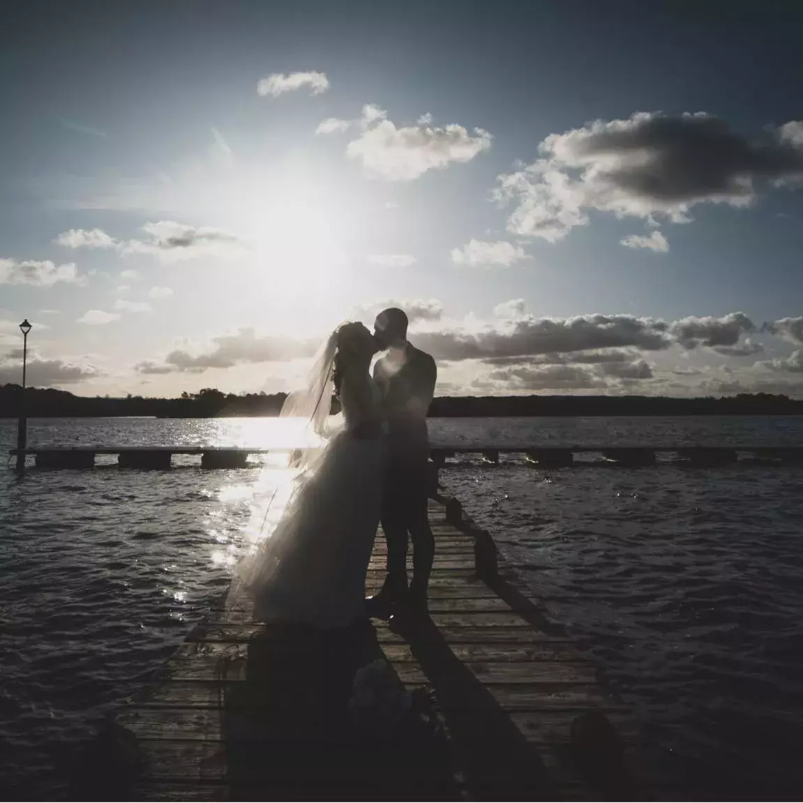 Bride & Groom kissing on the marina, situated at the Manor House Hotel