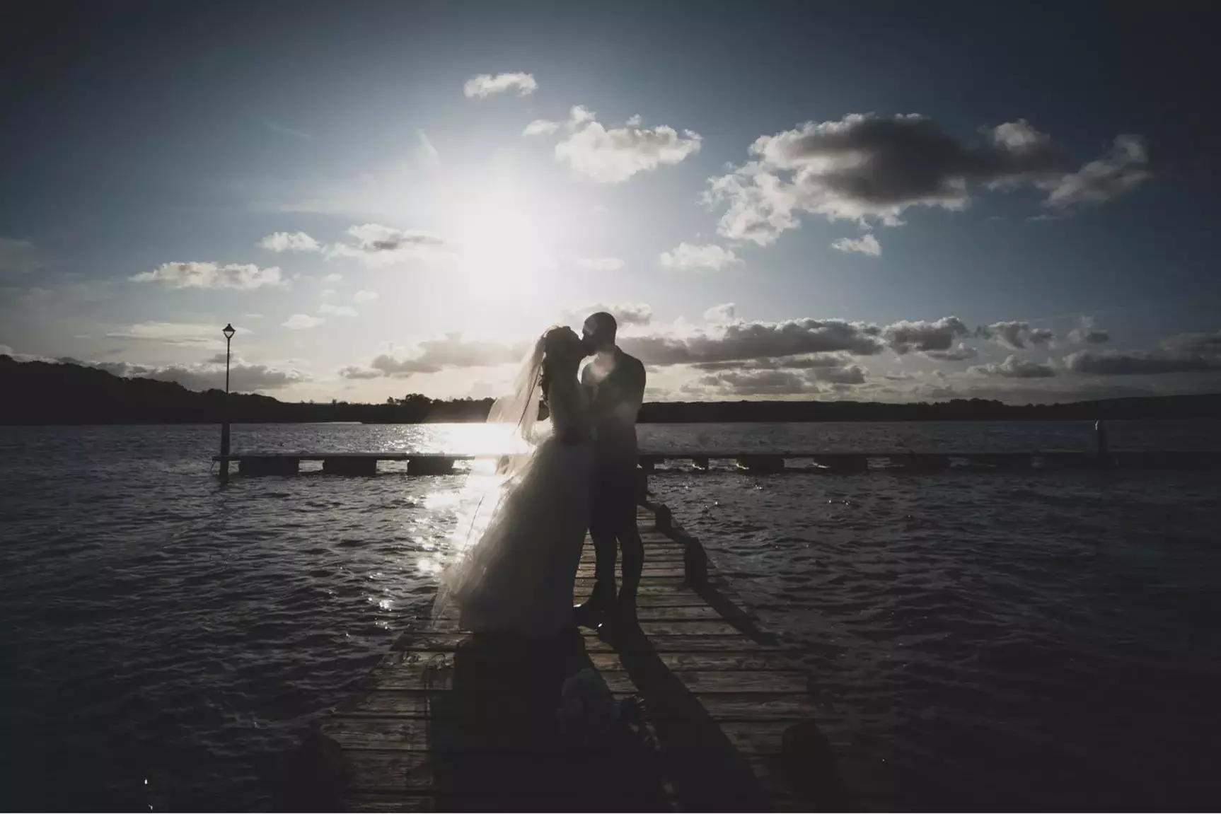 Bride & Groom kissing on the marina, situated at the Manor House Hotel