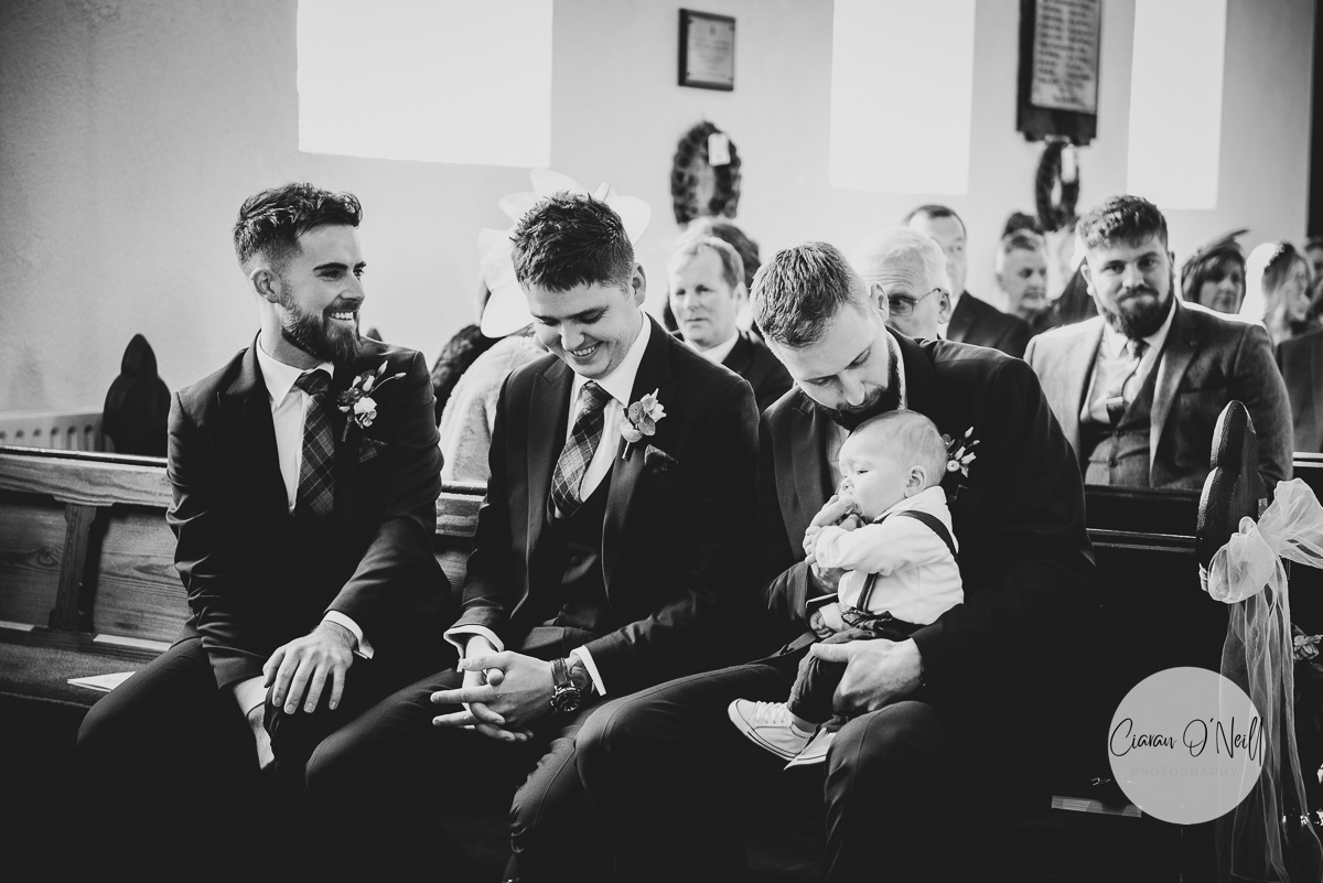 Groom kissing his son on the head
