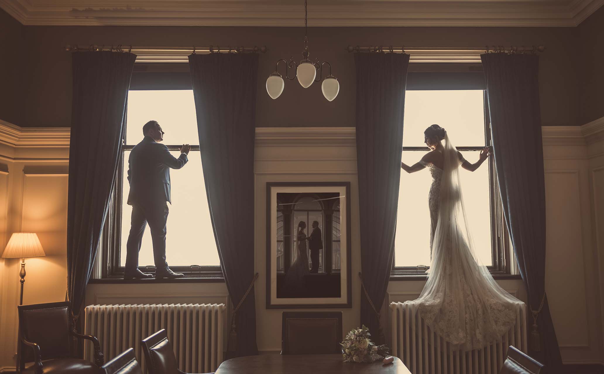 Titanic Hotel Wedding - Robyn & David standing in the window frames of the Ballroom