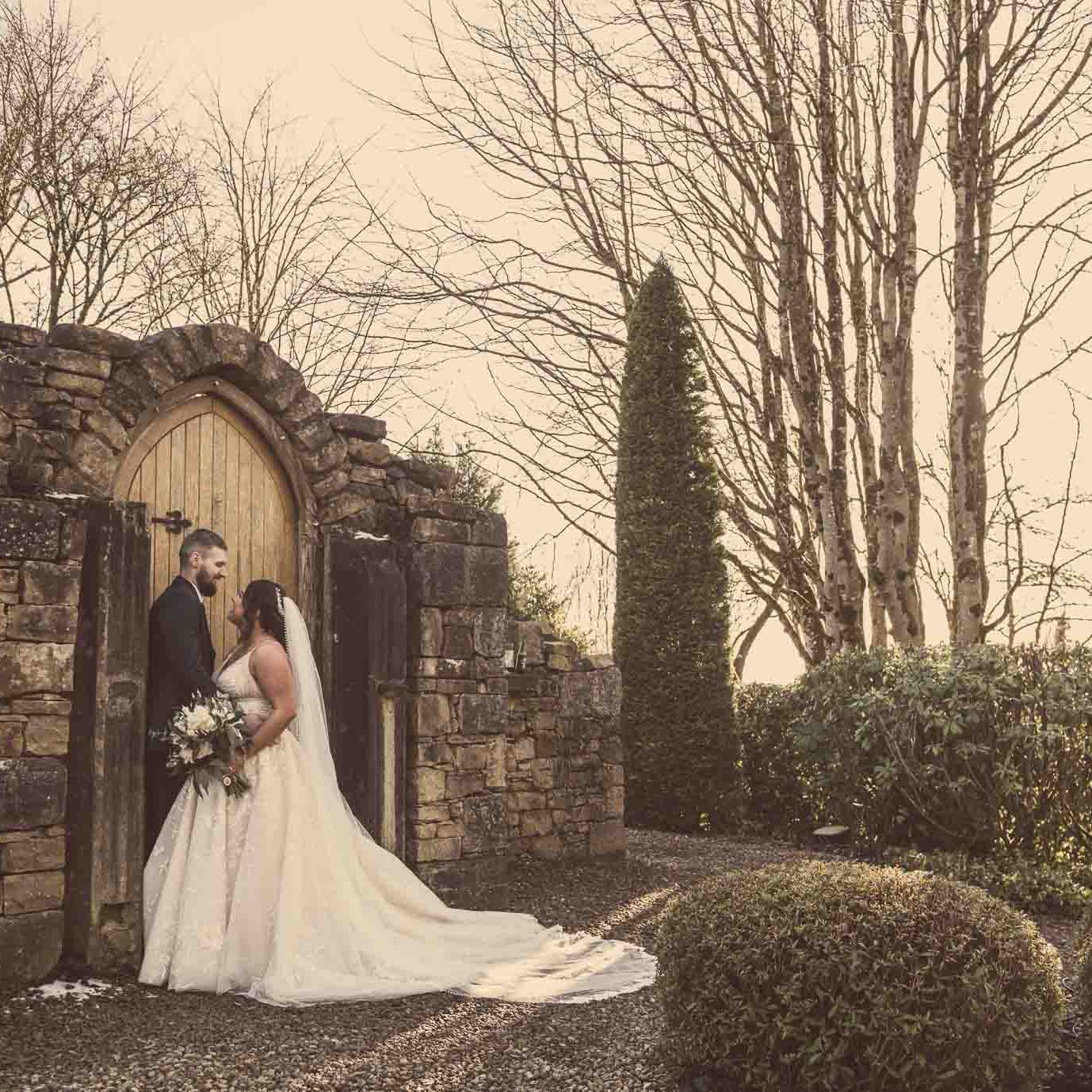 Victoria & Ryan embracing at the ruin in Slieve Russell Hotel