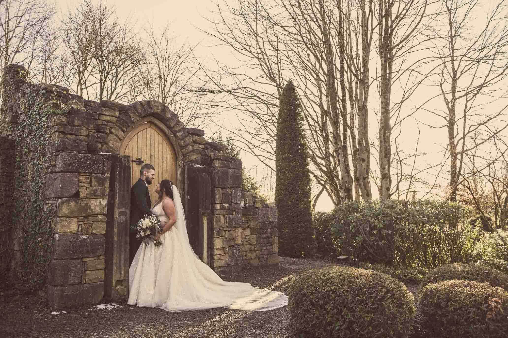 Victoria & Ryan embracing at the ruin in Slieve Russell Hotel