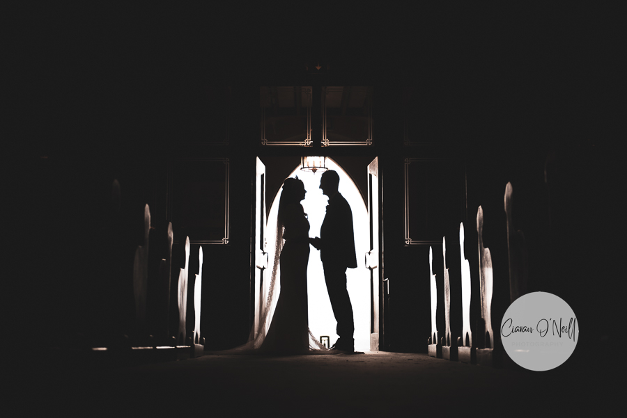 Silhouette of the bride and groom in the church door