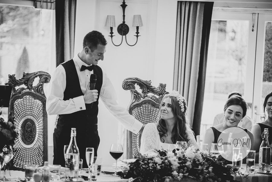 Bride looks emotional as her new husband tells a story of how they met