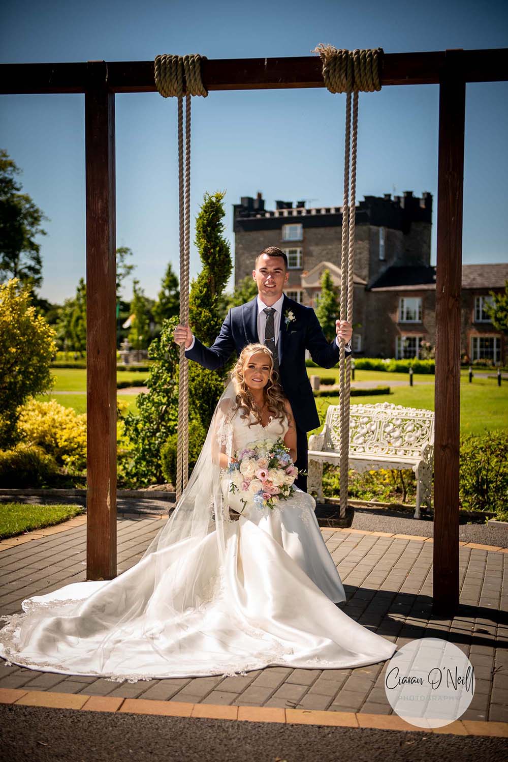 Groom holds swing for bride at Darver Castle