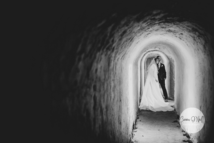 Couple embrace in a tunnel under Killeavy Castle
