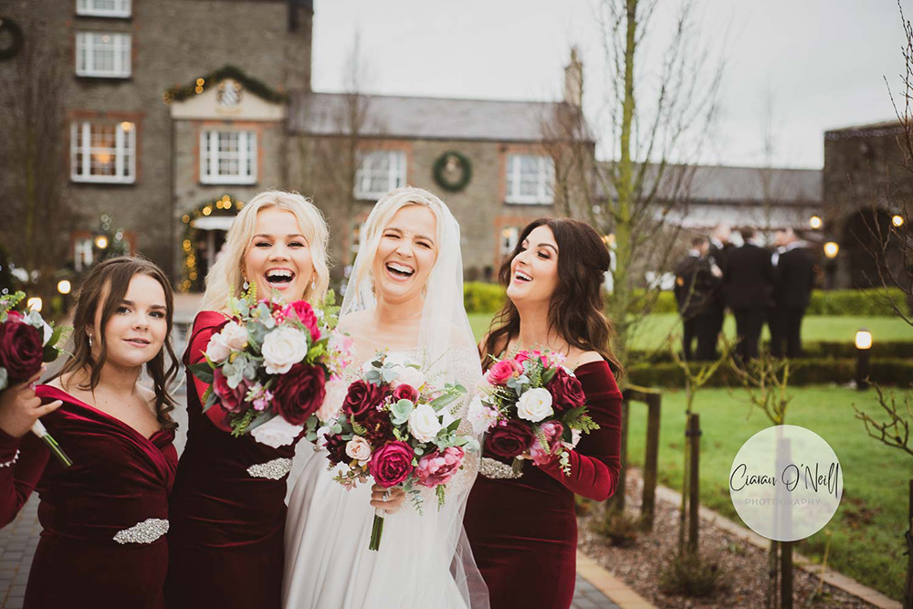 Bride and bridesmaids laughing outside Darver Castle