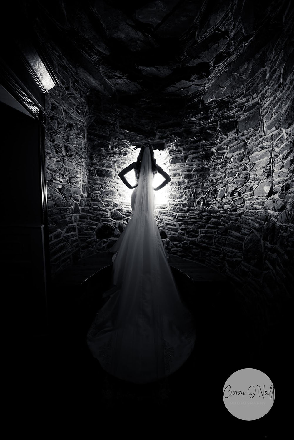 Bride in corner lit from behind Darver Castle