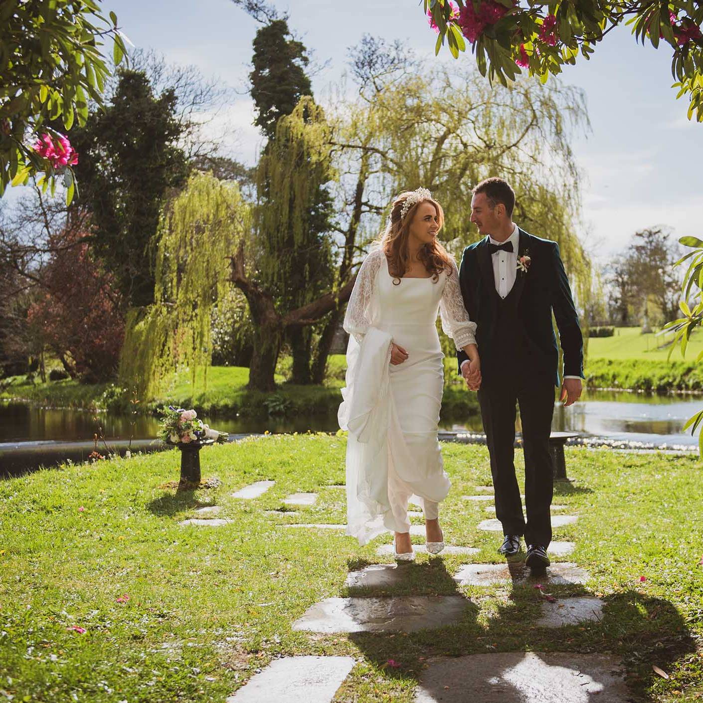 Bellingham Castle Wedding - Colleen & Seán emerge through the foliage as the sun shines on them