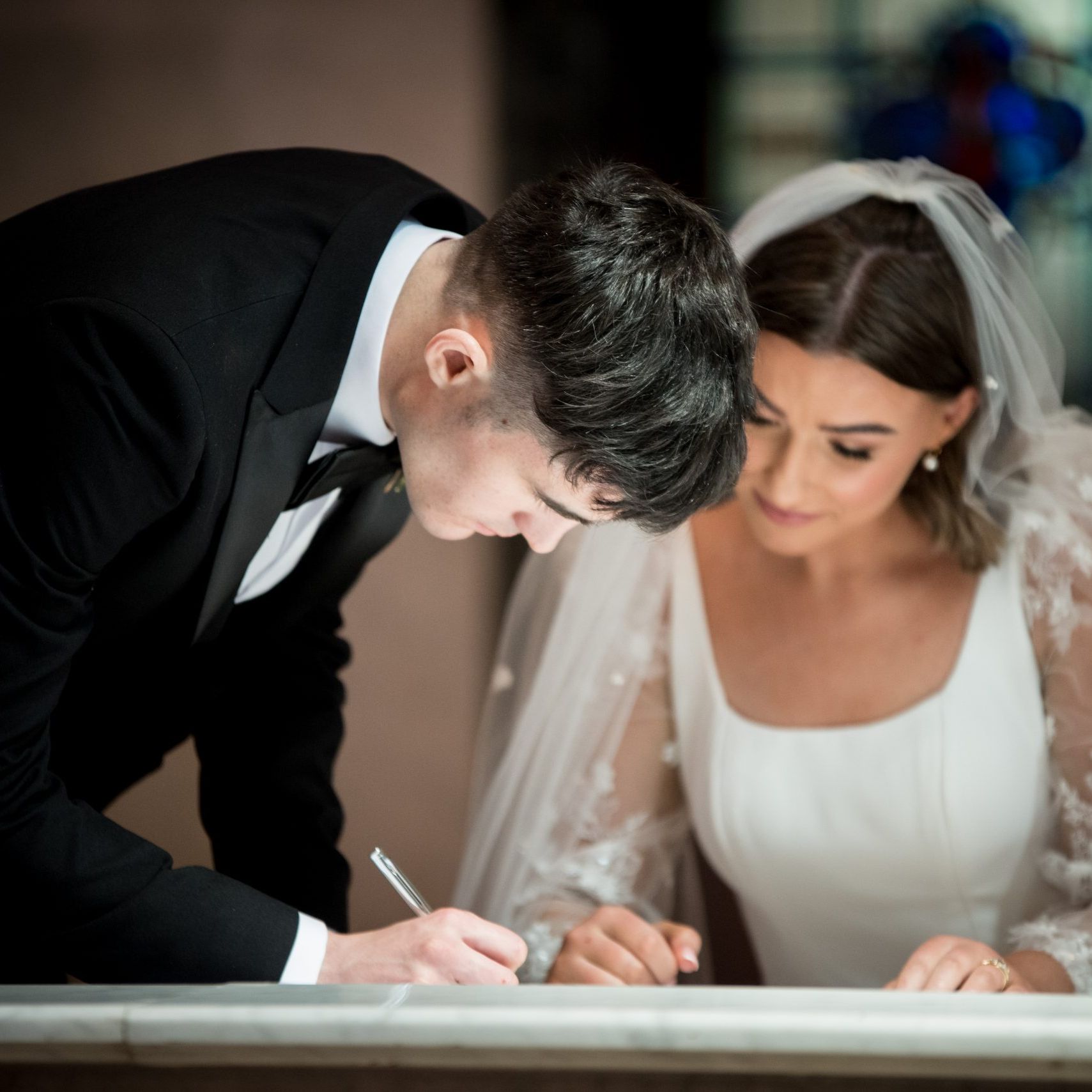 Georgia and Turlough signing register in St Patricks church Derrymacash by Ciaran O'Neill