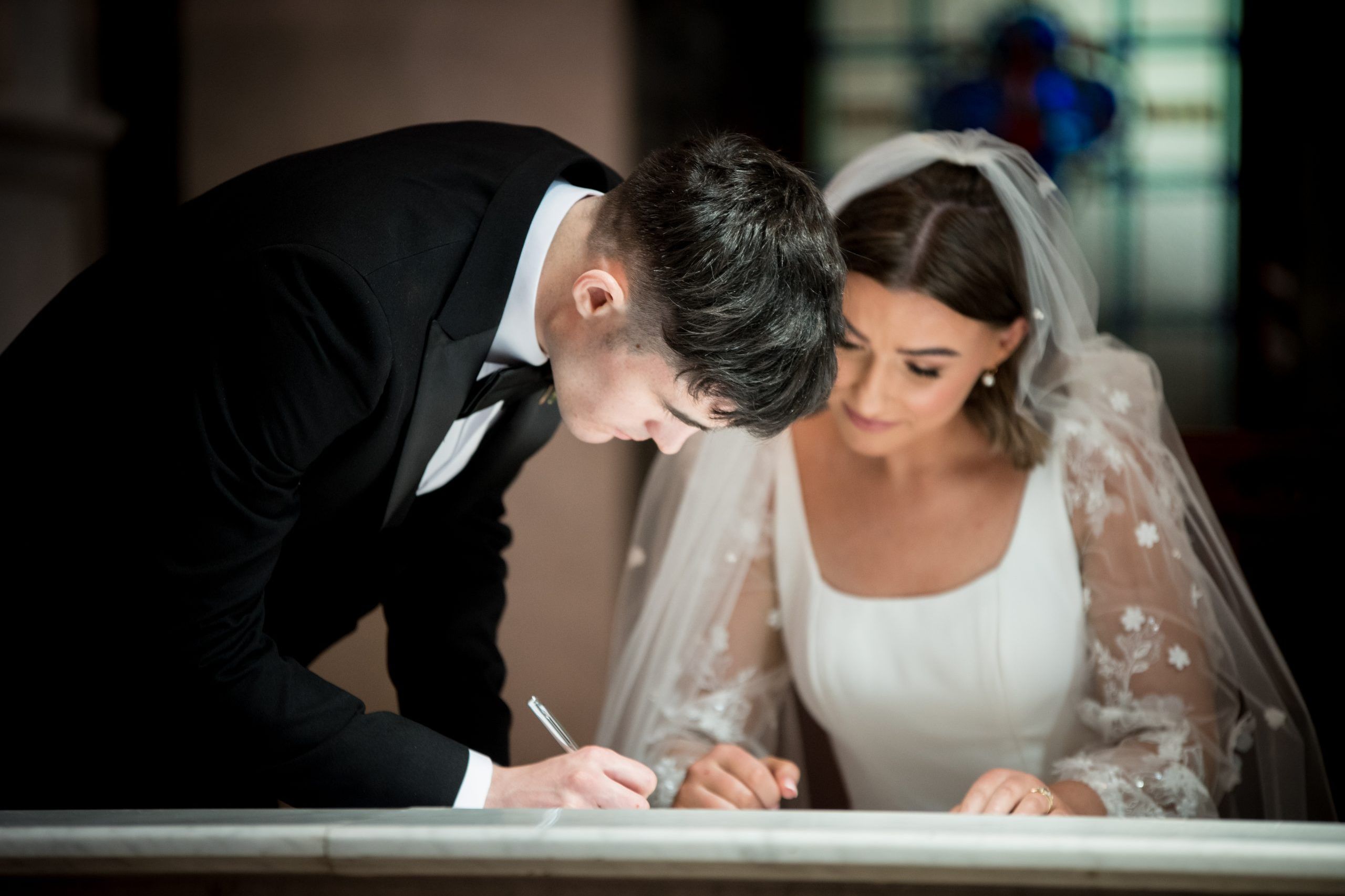 Georgia and Turlough signing register in St Patricks church Derrymacash by Ciaran O'Neill