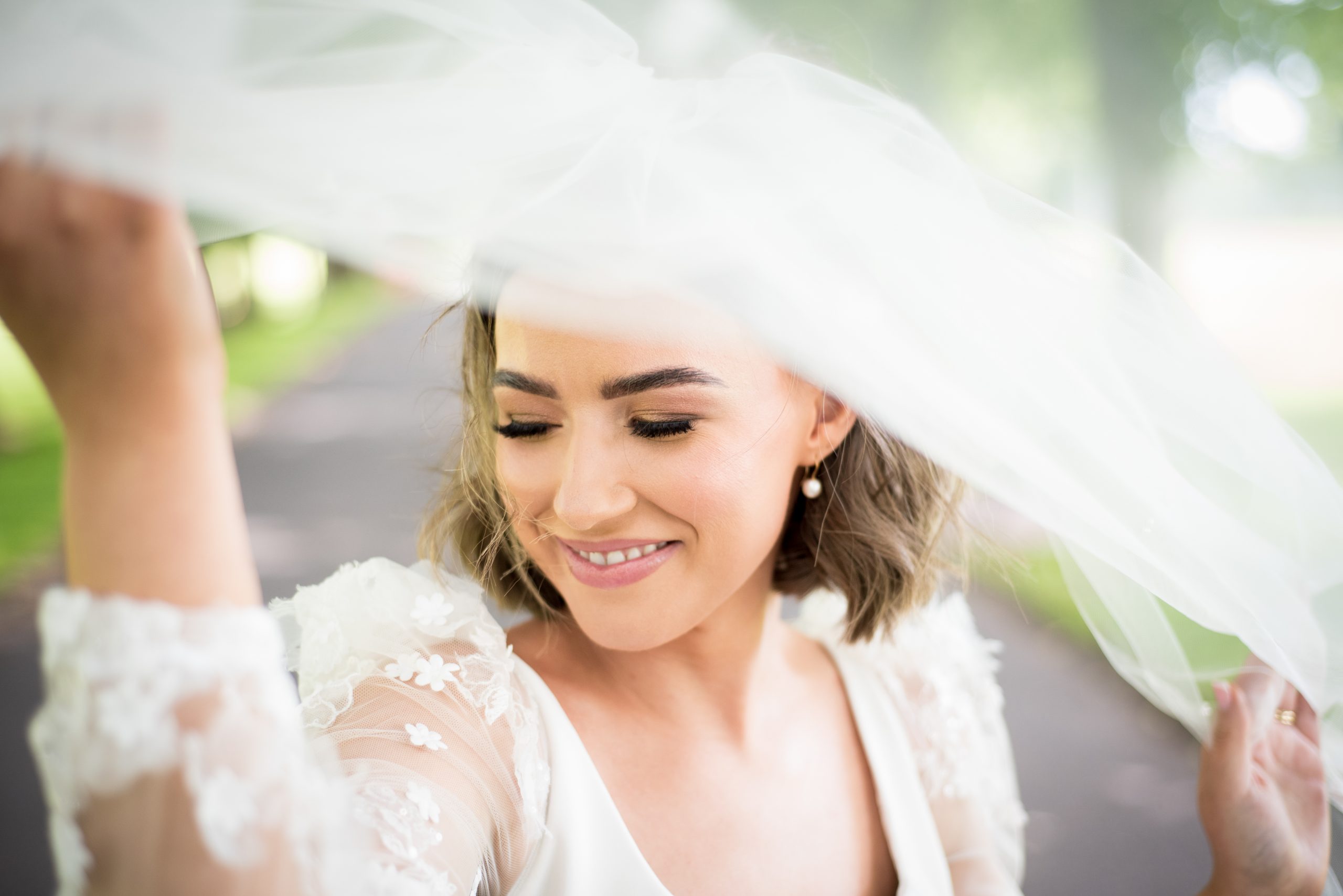 Bride under her veil in Lurgan Park by Ciaran O'Neill