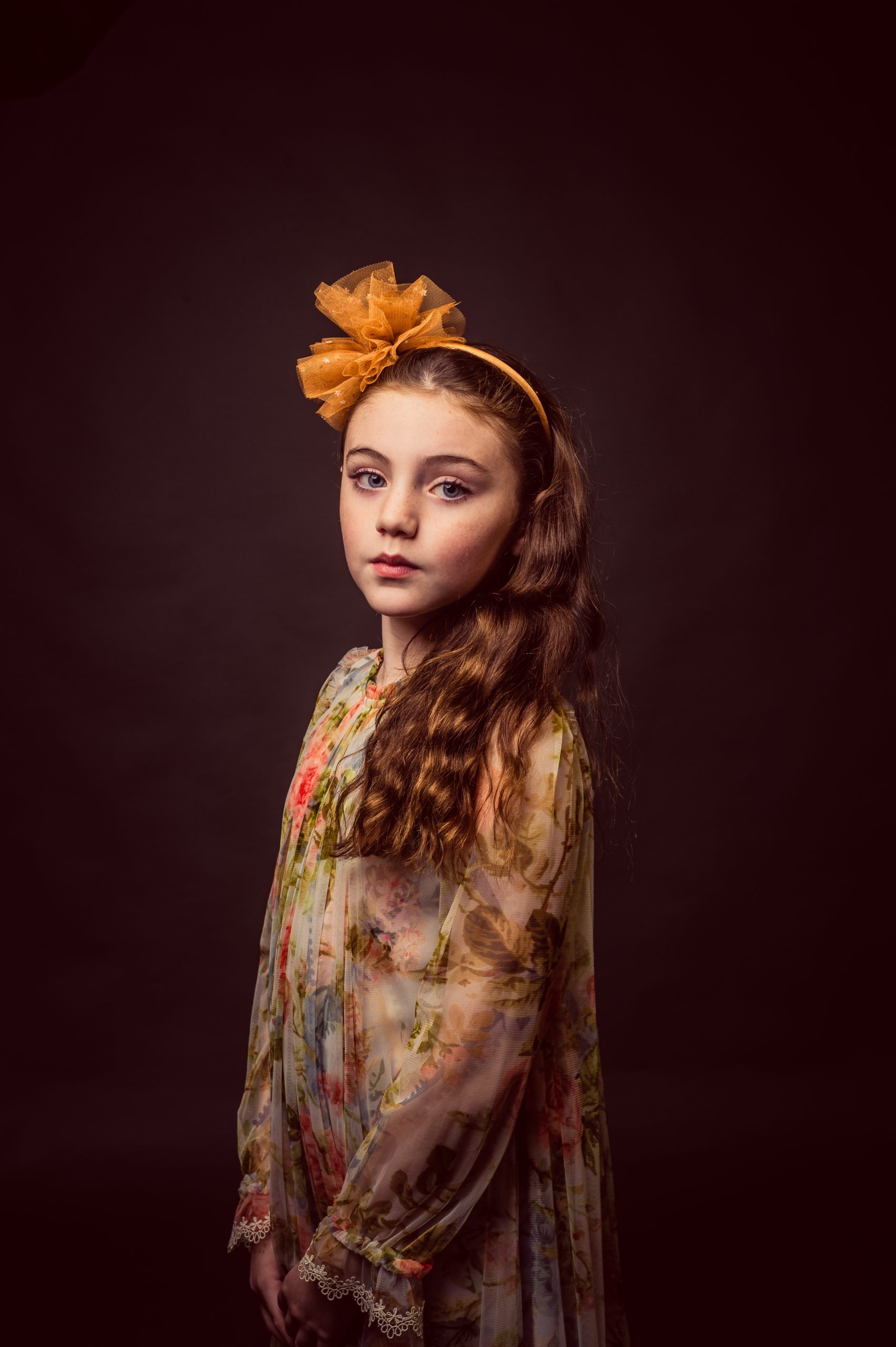 young girl in floral dress and a flower in her hair