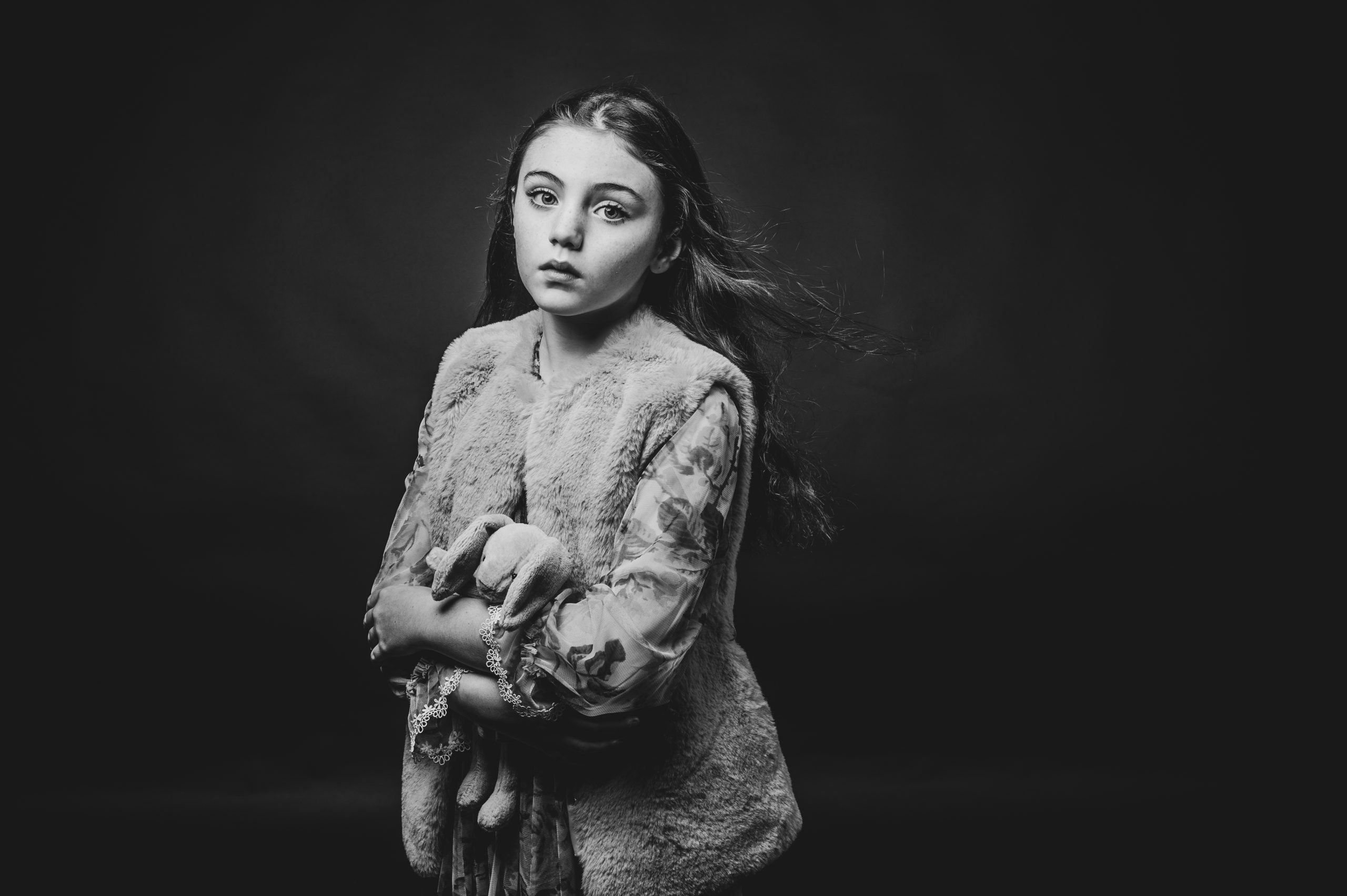 Young girl with long dark hair blowing in the wind