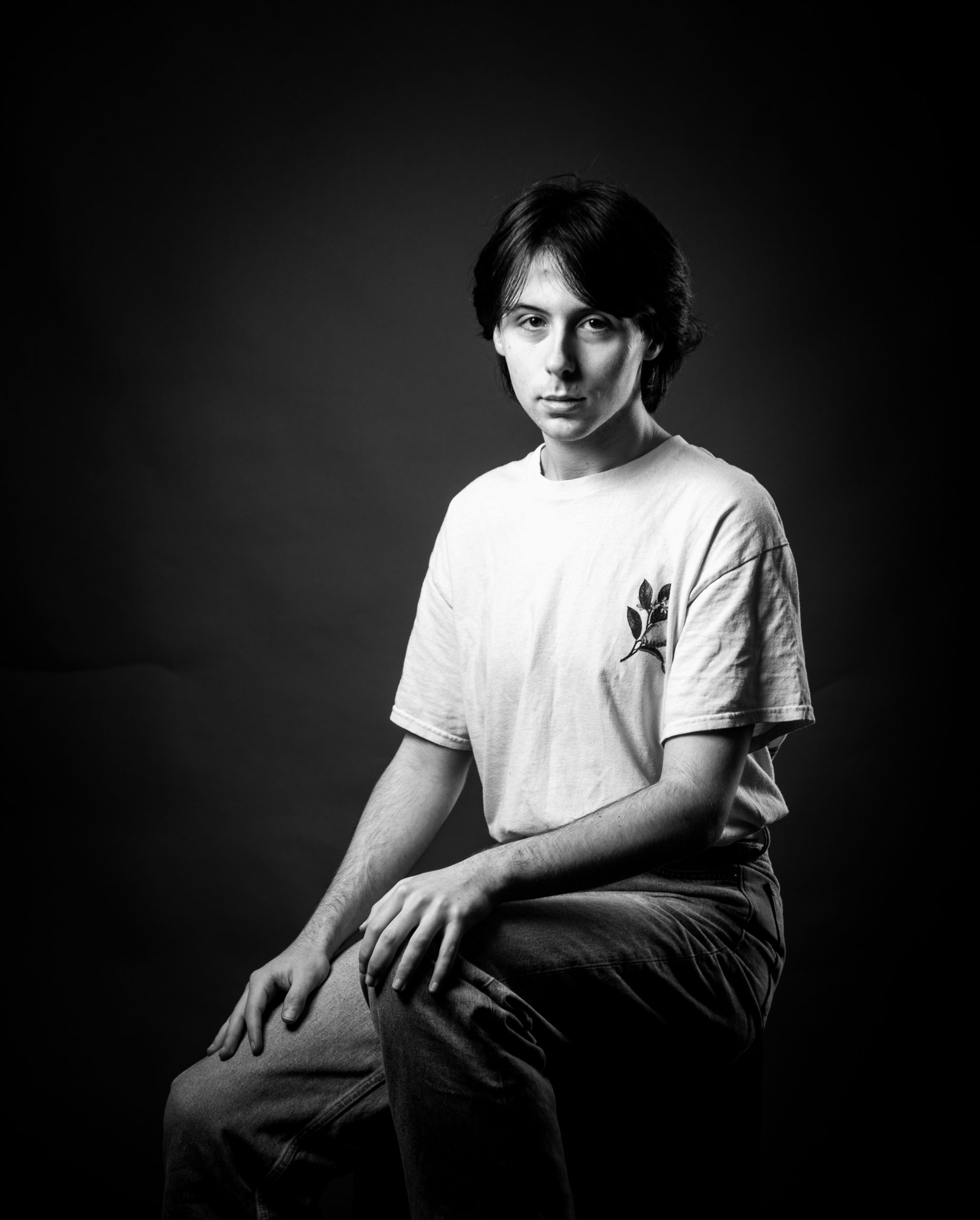 young man with hair in a middle shade in black and white