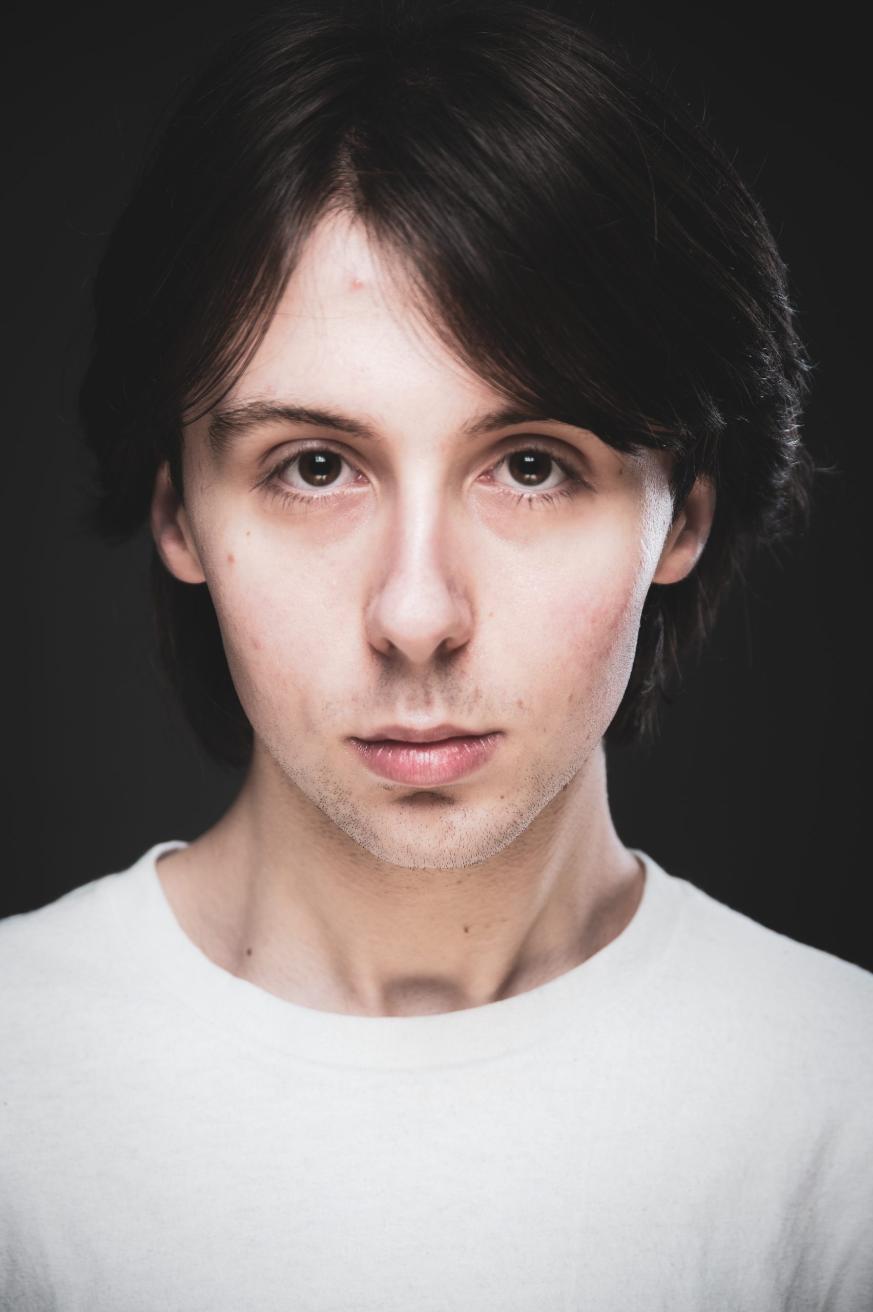 young man with dark hair and white tee shirt