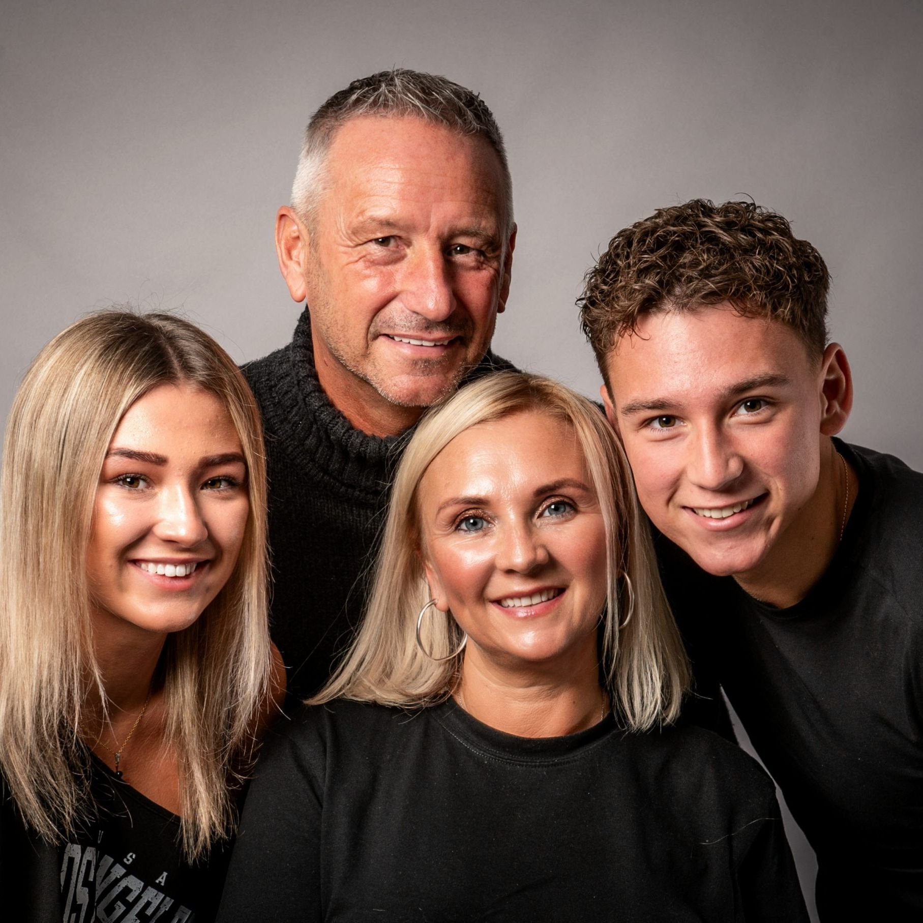 attractive family of four with mum, dad and teenage kids