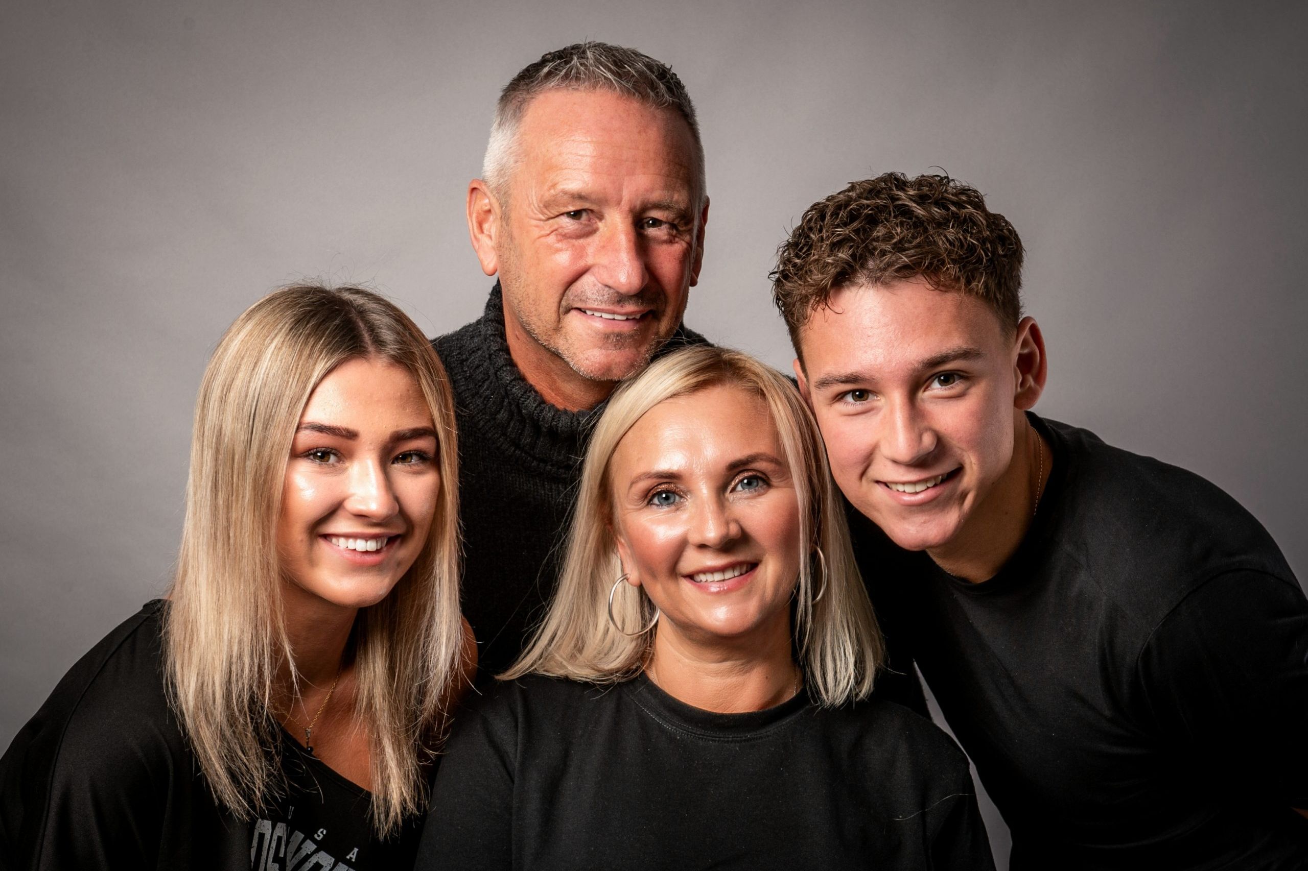 attractive family of four with mum, dad and teenage kids