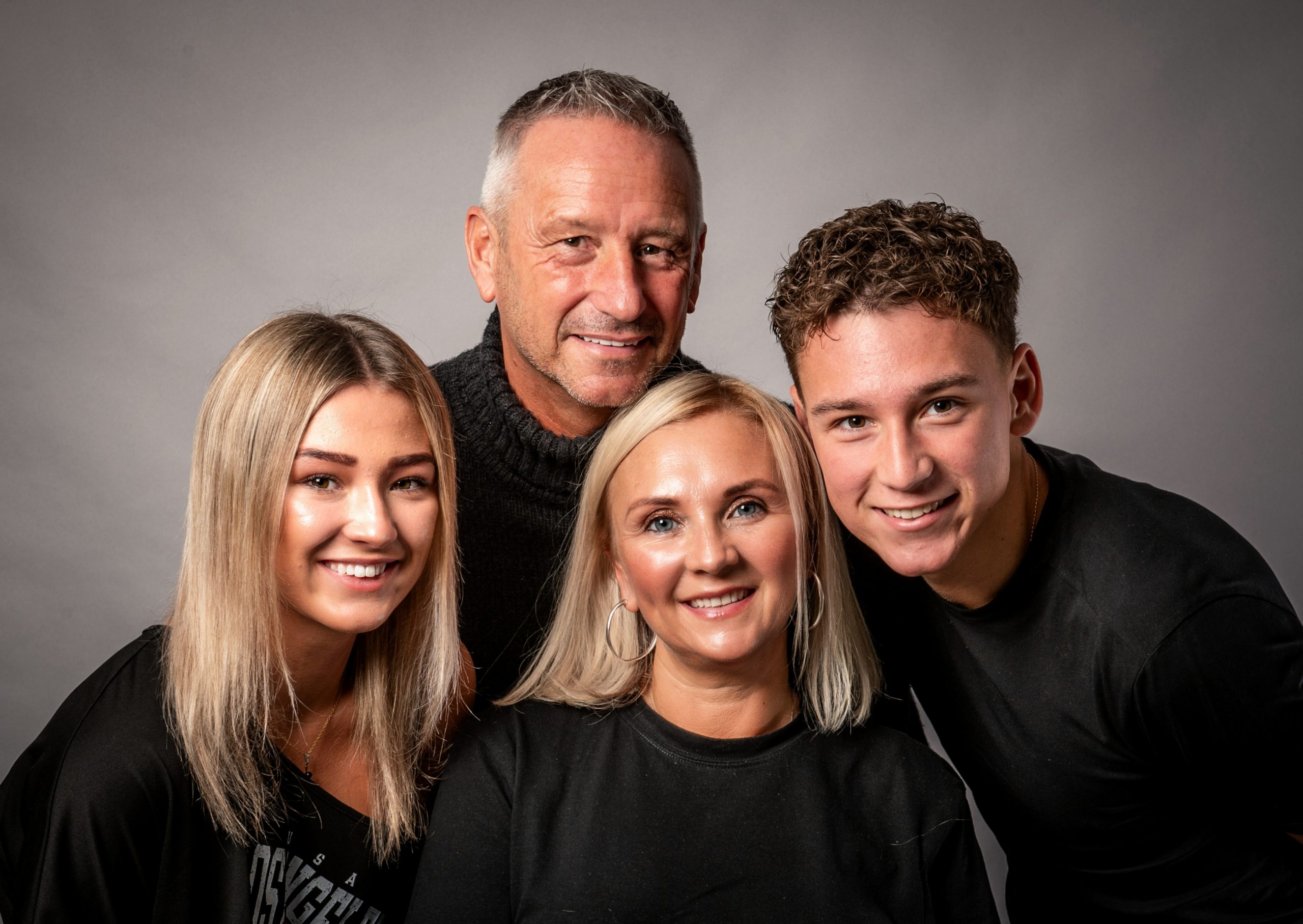 attractive family of four with mum, dad and teenage kids