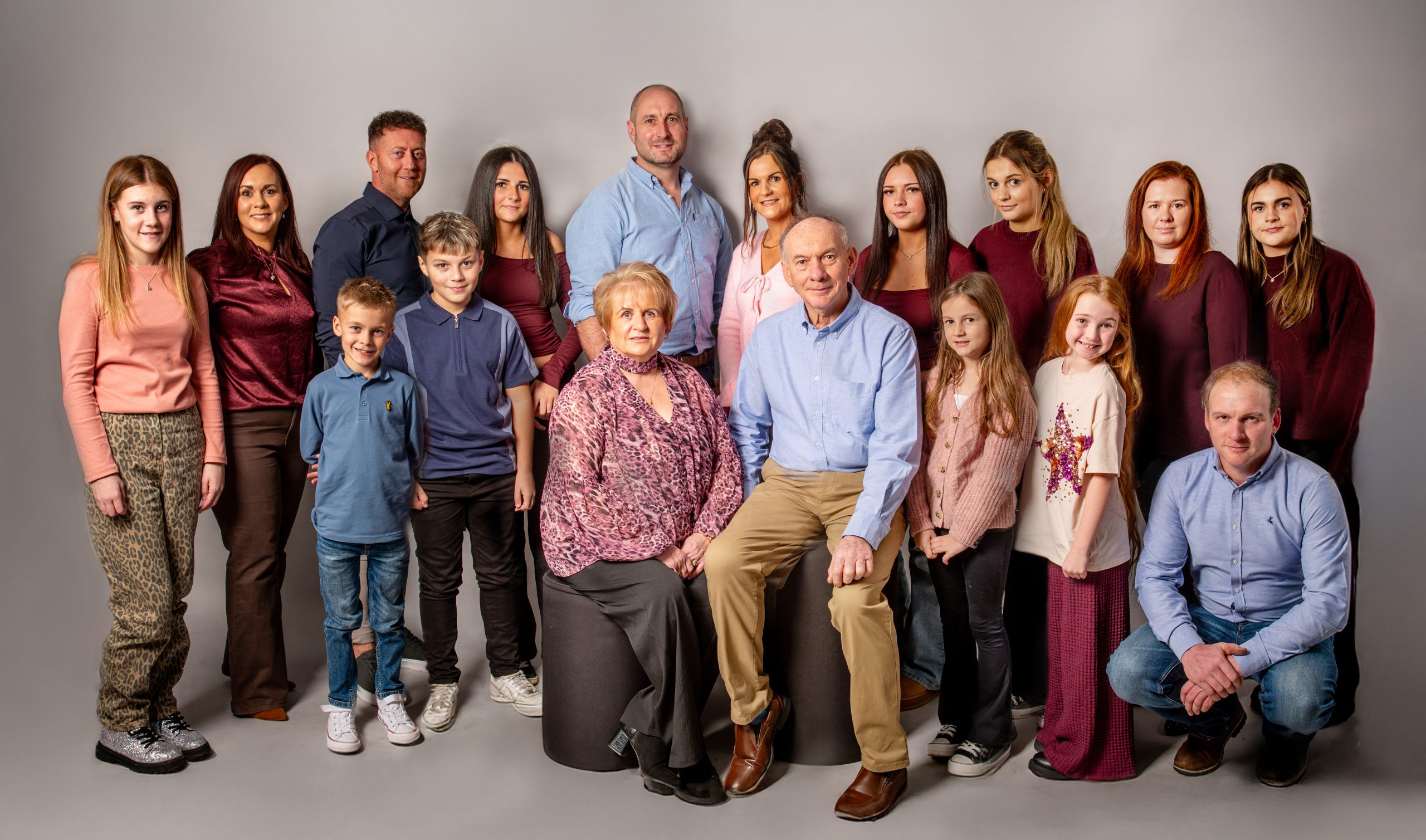 large family with three generations photographed in a studio
