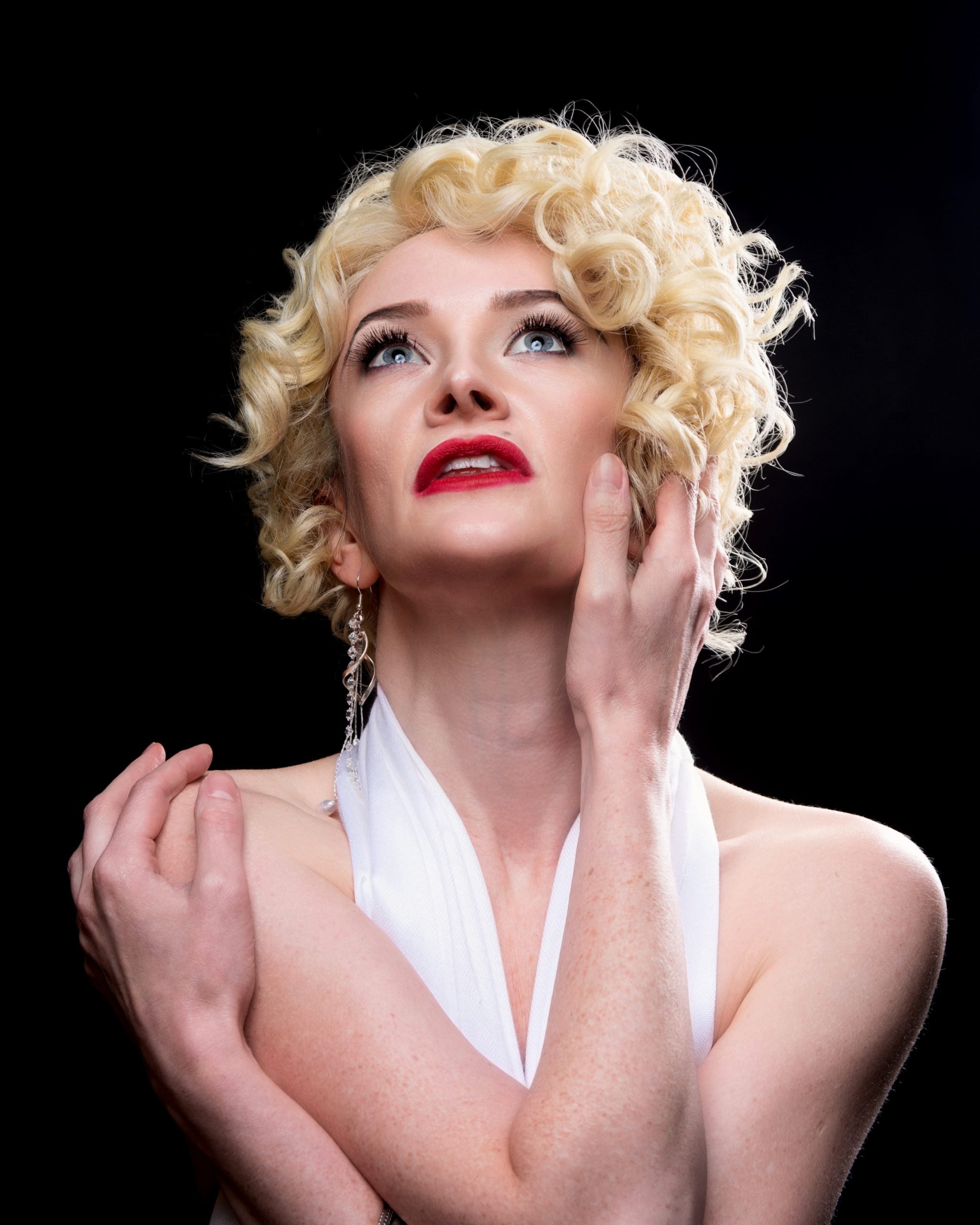 Blonde haired woman posing like Madona